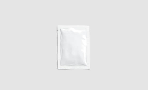 Blank white sachet packet mockup, isolated on gray background Blank white sachet packet mockup, isolated on gray background, 3d rendering. Empty disposable shampoo or conditioner pack mock up, top view. Clear sealed medication paket template. sachet stock pictures, royalty-free photos & images