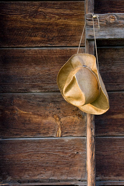 istock cowboy straw hat against weathered wood 117179422