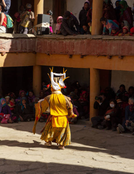 Monk in deer mask with ritual sword performs religious mystery dance of tTantric Tibetan Buddhism on the Cham Dance Festival Korzok,India - July 23, 2012: unidentified monk in deer mask with ritual sword performs religious mystery dance of tTantric Tibetan Buddhism on the Cham Dance Festival in Korzok monastery cham mask stock pictures, royalty-free photos & images