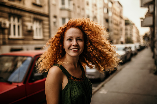 young woman portrait city outdoors at sunset