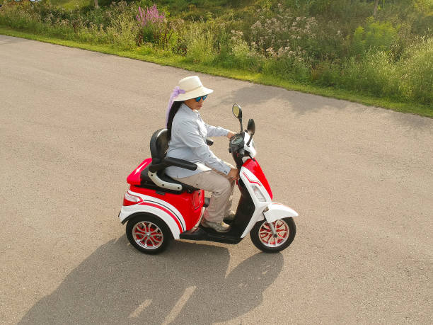 istock Disabled person driving a motorized mobility scooter for elderly and or disabled. Recreational electric ability vehicle for handicapped aerial. Accessibility concept. 1171799314