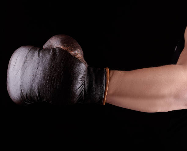 istock man's hand is wearing a brown leather boxing glove 1171799326