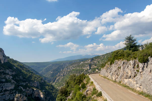 istock Empty road in the Canyon Gorges de la Nesque, gray cliffs with green forest in summer sunny day in Provence, South France 1171799507