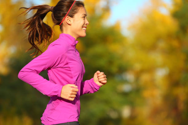 istock Woman running in autumn fall forest 1171799586