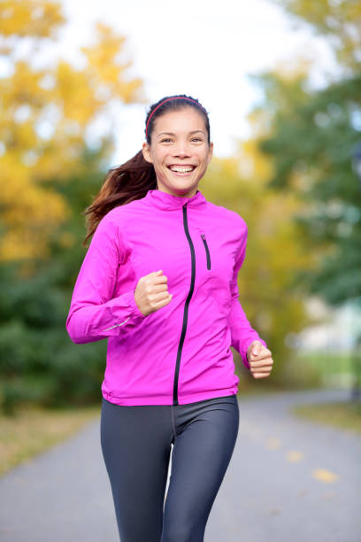 istock Running sport woman training in fall autumn forest 1171799651