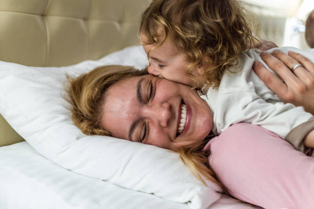 istock Happy family having fun on bed 1171800823
