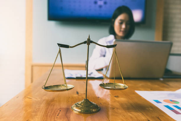 istock Gold brass balance scale over with lawyer background. 1171800829