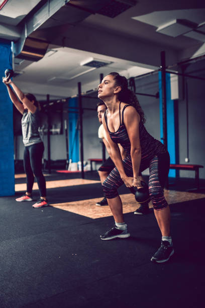 istock Female Athlete Lifting Kettlebell With Mighty Effort 1171800852
