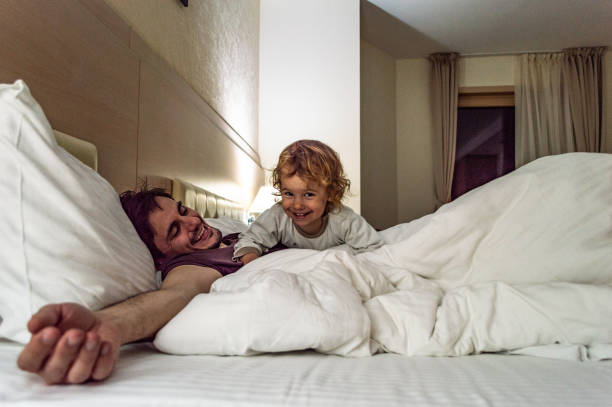 istock Happy family having fun on bed 1171800905