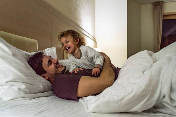 istock Happy family having fun on bed 1171800938