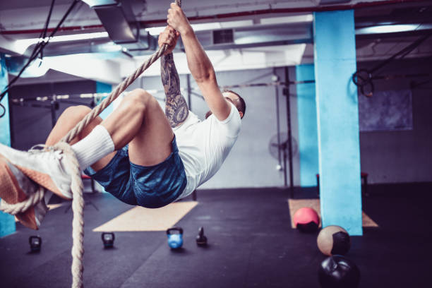 istock Male Climbing Rope In Gym 1171800959