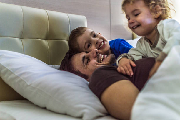istock Happy family having fun on bed 1171801008