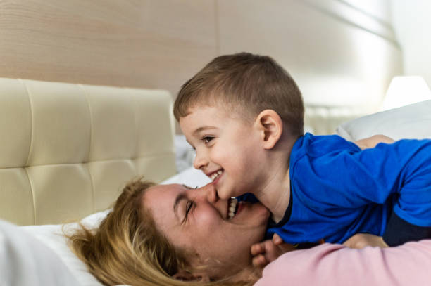 istock Happy family having fun on bed 1171802748