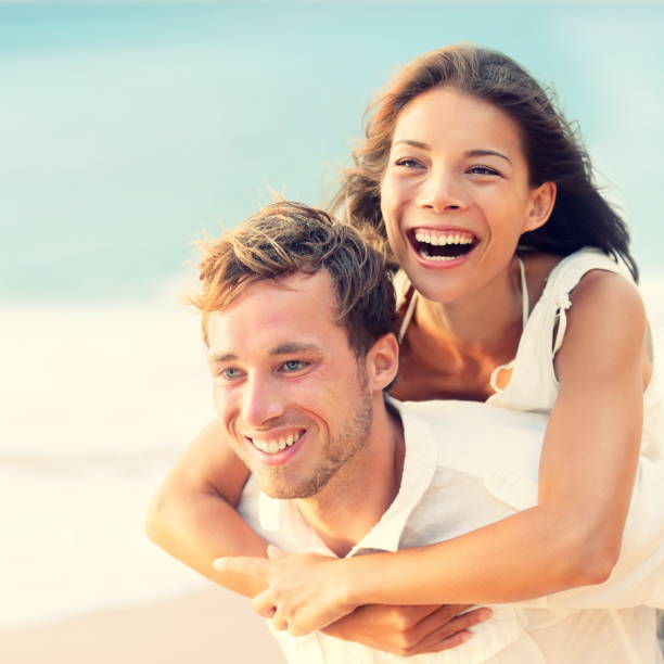 istock Love - Happy couple on beach having fun piggyback 1171804160