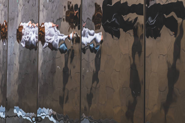 istock Distorted reflection and shadow of pedestrians on the ceiling of a canopy 1171804685