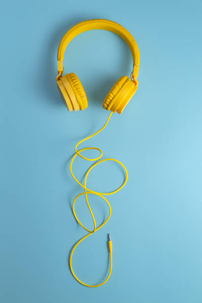 istock Yellow headphones on blue background. Music concept. 1171805457