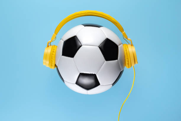 Yellow Headphones On The Traditional Style Soccer Ball Over Blue Background  Music Concept Stock Photo - Download Image Now - iStock