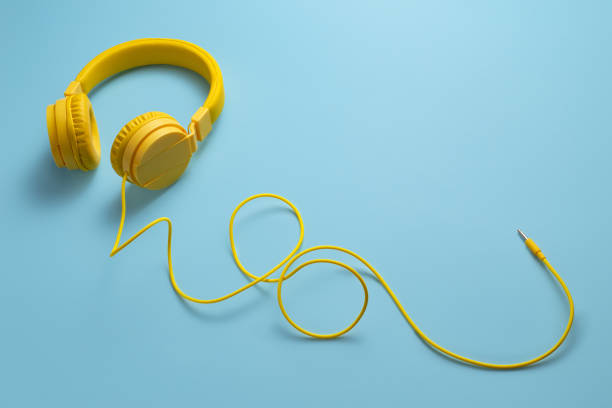 istock Yellow headphones on blue background. Music concept. 1171805471