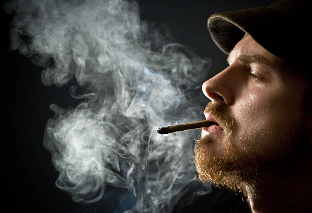 Bearded man smoking stock photo