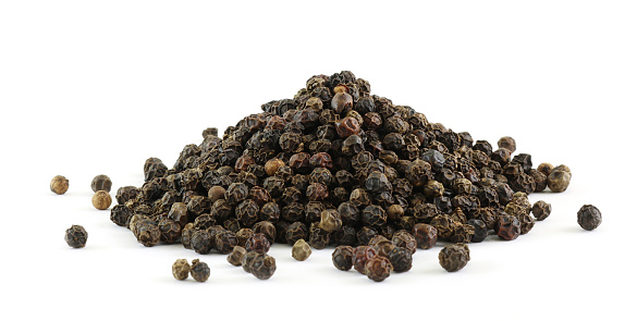 pile of whole black peppercorns, isolated on white background
