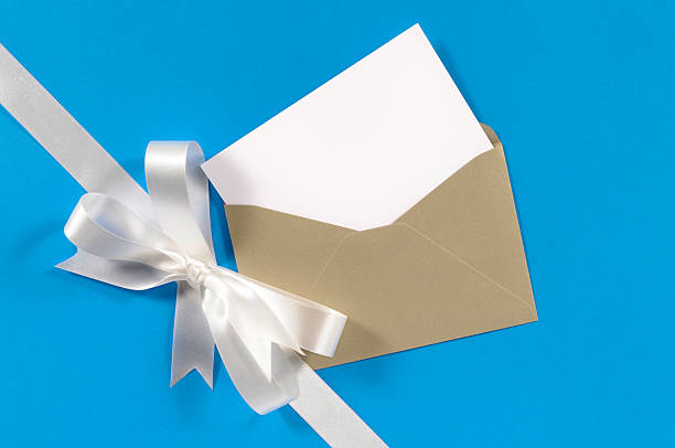 istock White gift ribbon on blue paper with blank card 117180823