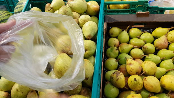 istock Using a plastic bag to buy fruit at the supermarket 1171812098