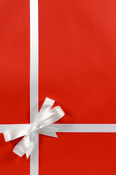 istock White gift ribbon on red paper 117181213