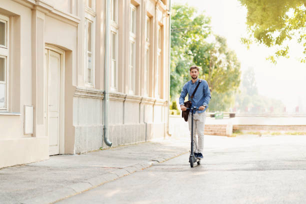 istock Young businessman riding an electric push scooter on his way to work 1171813391