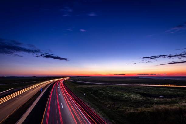 Flint Hills traffic Turnpike at dusk in the flint hills of Kansas multiple lane highway stock pictures, royalty-free photos & images