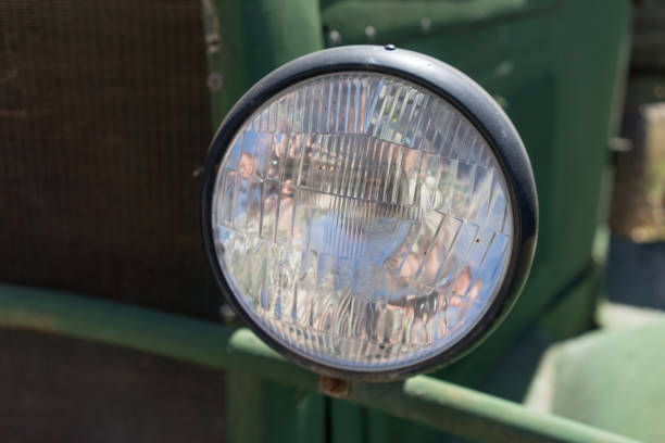 istock Old car headlight on a green background. 1171814330