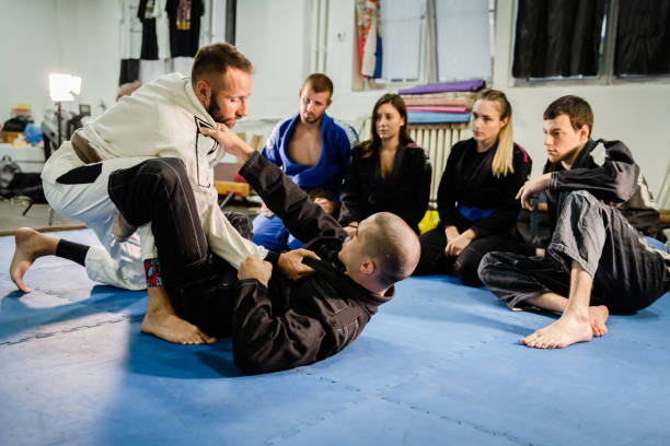 istock Brazilian Jiu JItsu BJJ professor teaching technique from the guard position to his students in training class at the martial arts academy 1171817204