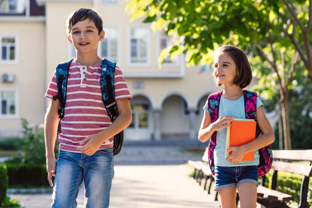 istock Back to school. Happy kids walking with backpacks 1171817321