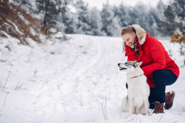 istock Beautiful woman playing with a dog 1171817934