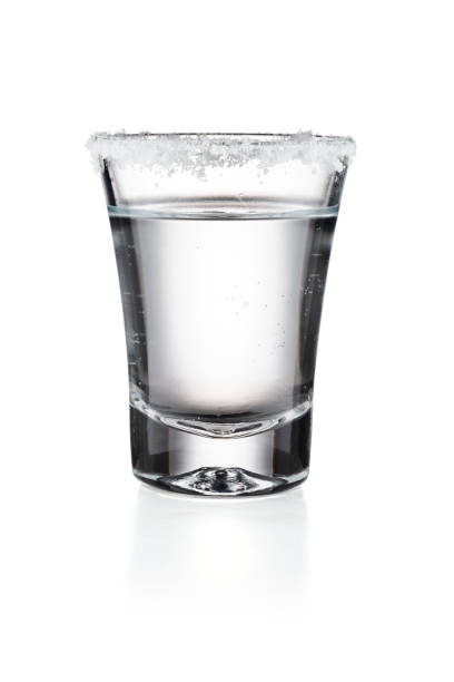 tequila in a glass with salt isolated white background - tequila shot imagens e fotografias de stock