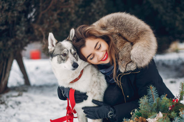 istock Beautiful woman playing with a dog 1171819640