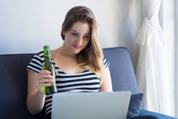 istock Young woman using a laptop computer at home 1171820501