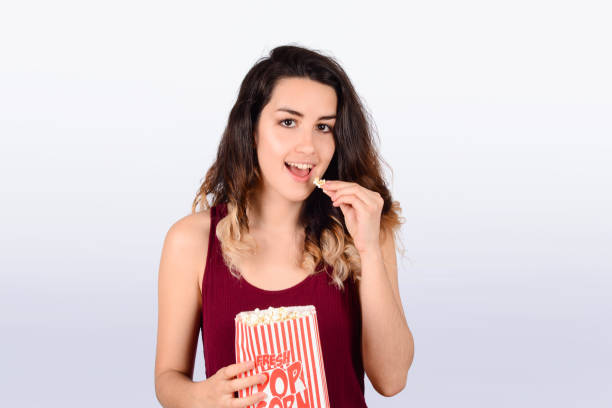 istock Young woman watching eating popcorn. 1171820574