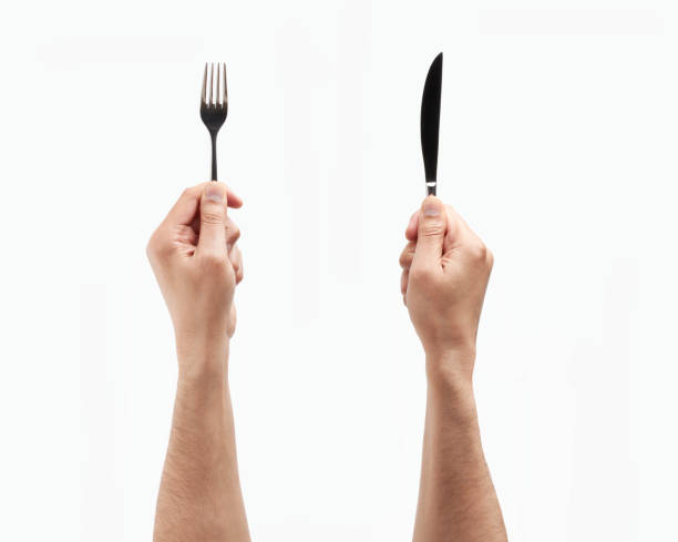 hands holding a fork and a knife - eating eat silverware horizontal imagens e fotografias de stock