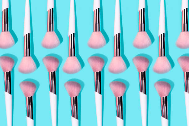 istock Pattern made of make up white brush on turquoise background. 1171825252