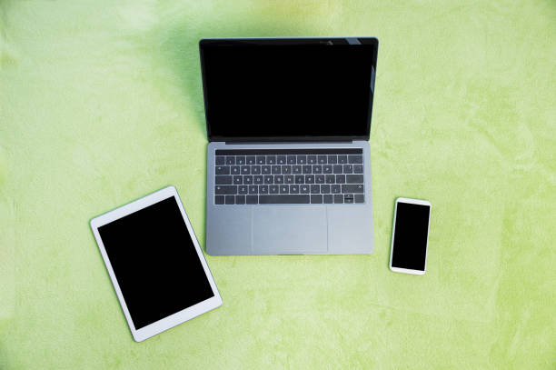 Shot of various digital devices on a green carpet at home