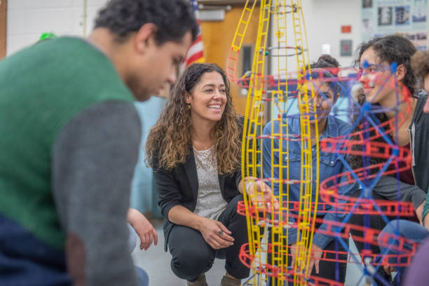 istock Ethnic art teacher shows her class a colorful example of sculpture 1171825942