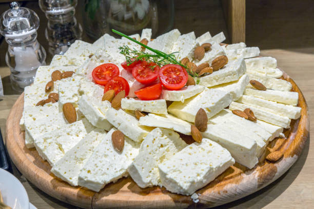 istock Goat cheese with almonds served on wooden board 1171825987