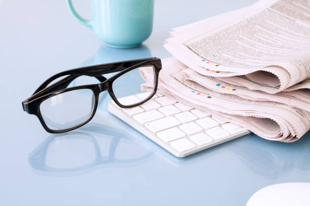newspaper and coffee cup over wooden table