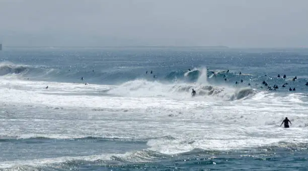 Photo of Big crowd of surfers in tall waves near Balboa Pier, Newport Beach, Southern California