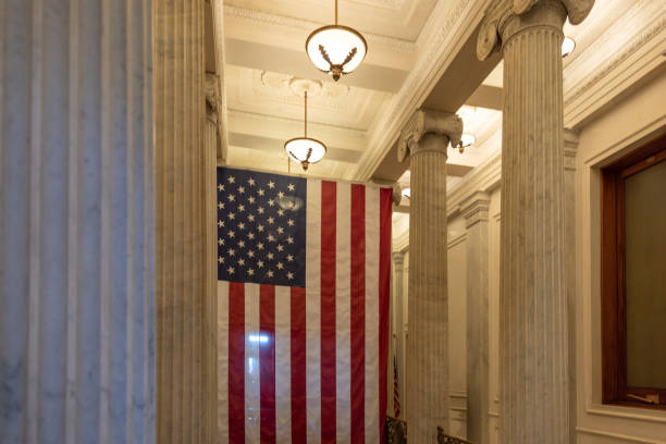 A US flag hanging at the corridor ceiling of US Capitol corridor ceiling, Interior, Washington DC A US flag hanging at the corridor ceiling of US Capitol corridor ceiling, Interior, Washington DC. united states capitol rotunda photos stock pictures, royalty-free photos & images
