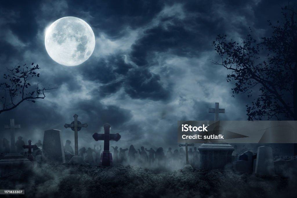 Zombie Rising Out Of A Graveyard cemetery In Spooky dark Night Zombie Rising Out Of A Graveyard cemetery In Spooky dark Night full moon. Holiday event halloween concept. Halloween Stock Photo