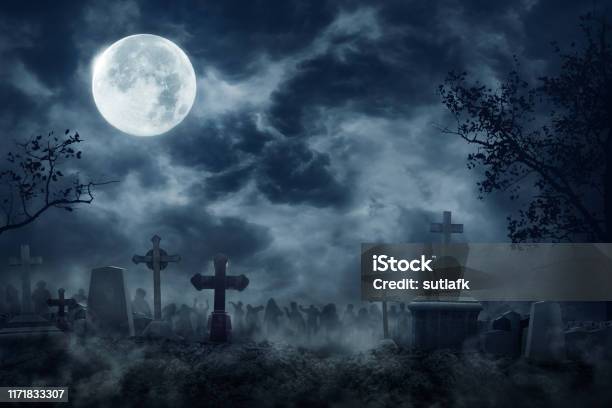 Zombie Rising Out Of A Graveyard Cemetery In Spooky Dark Night Stock Photo - Download Image Now