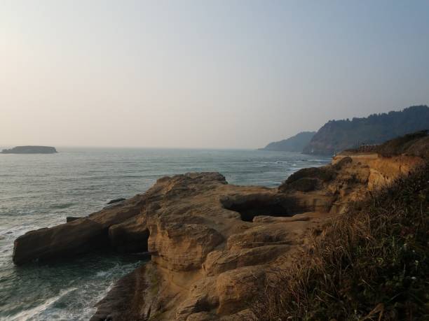 istock large hole in cliff at Oregon coast with ocean and waves 1171835031