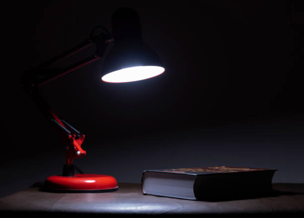 istock The lamp and the book on the table. 1171835228