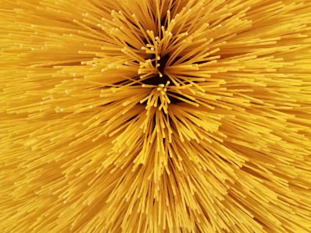 skinny hard yellow plastic material up close that looks like spaghetti